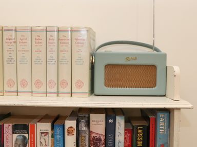 A shelf with historical books and a portable radio at The Riblows Cape Cornwall Bollowal near St Just