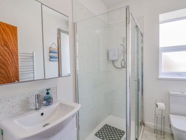 A bathroom with a sink soap dispenser shower enclosure and toilet at 4 Seaview Bridlington Bay Bridlington