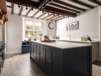 A kitchen with a large island and window seating at Fron Dderw in Bala