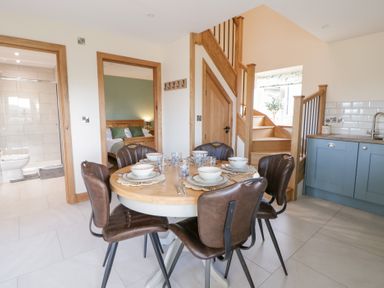 A dining room with a table and chairs at Y Stabal near Llanilar