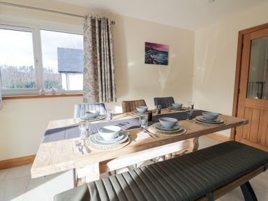 A dining room with a table set for a meal at Beudy near Llanilar