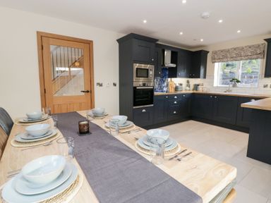 A kitchen with a dining table set at Beudy near Llanilar