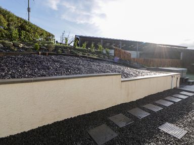 A garden with gravel and landscaped stones at Beudy near Llanilar