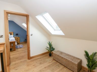 A bedroom with a woven bench and skylight at Beudy near Llanilar