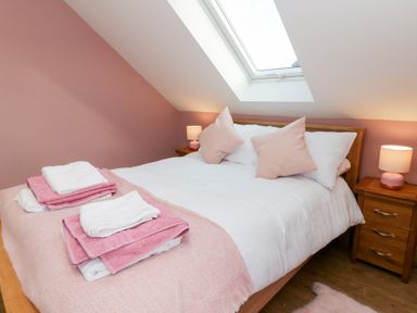 A bedroom with a bed and bedside tables at Beudy near Llanilar