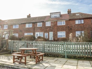 A house with a fence and garden furniture at Whitby View in Whitby