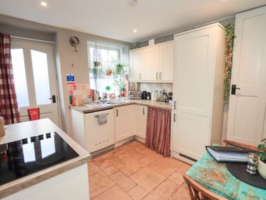 A kitchen with cabinets and a sink at Gosling Cottage in Kendal