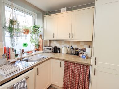 A kitchen with a sink and appliances at Gosling Cottage in Kendal