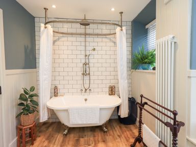 A bathroom with a bathtub and shower in Gosling Cottage Kendal