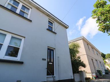 Exterior view of a two-story house with windows and a black door at 8 Rosewall Cottages in St Ives