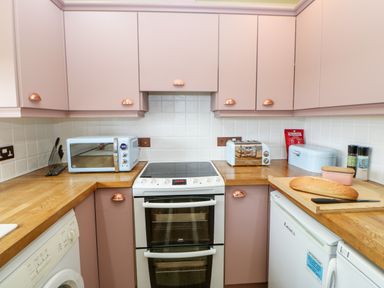 A kitchen with a stove microwave toaster bread and appliances at The Granary in Longwitton near Morpeth