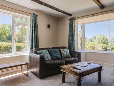 A living room with a sofa and coffee table at Woodstock in Chard