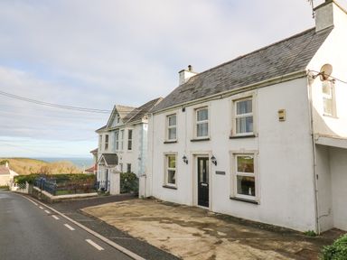 A street view with two houses and a driveway near the coast at Towyn Hall in New Quay