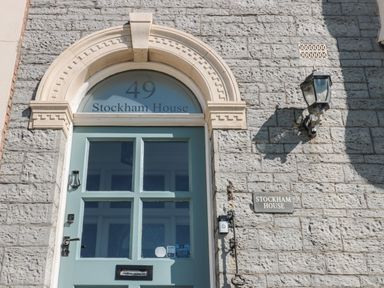 The front door of Stockham House with the number 49 above it on a stone building at 49 Esplanade Burnham-On-Sea