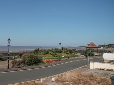 A coastal road with lampposts and flowers near the beach at 49 Esplanade in Burnham-On-Sea