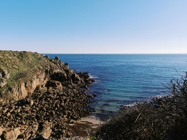 A rocky coastline with cliffs and the ocean at Pendower Cottage in Porthgwarra
