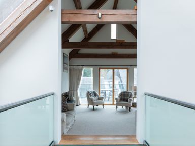 A living room with armchairs a sofa and wooden beams at Gull Rock 4 in Rock