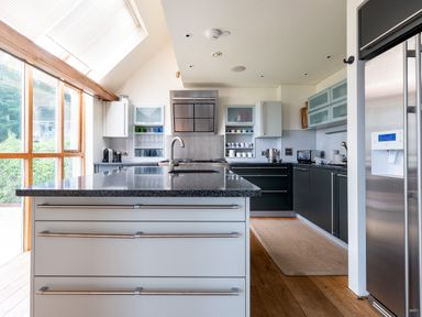 A kitchen with an island countertop sink cabinets and stainless steel refrigerator at Gull Rock 4 Rock