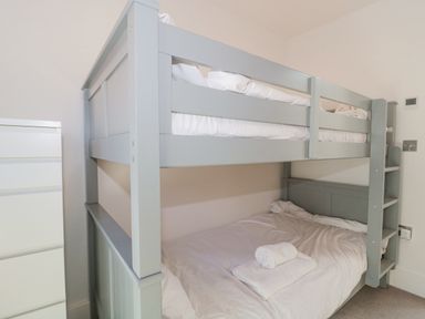 A bedroom with a gray bunk bed and white dresser at Agua de Plata 16 Wakeling Island Silverlake in Dorchester