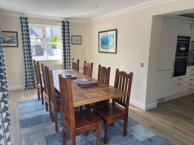 A dining room with a table and chairs at 3 Strawberry Close Little Haven near Broad Haven