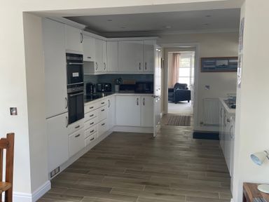 A kitchen with cabinets and appliances at 3 Strawberry Close Little Haven near Broad Haven