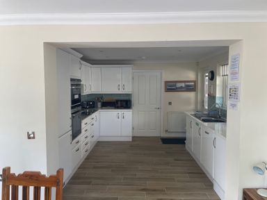 A kitchen with cabinets and appliances at 3 Strawberry Close Little Haven near Broad Haven