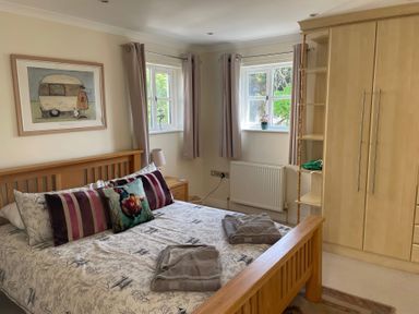 A bedroom with a bed and wardrobe at 3 Strawberry Close Little Haven near Broad Haven