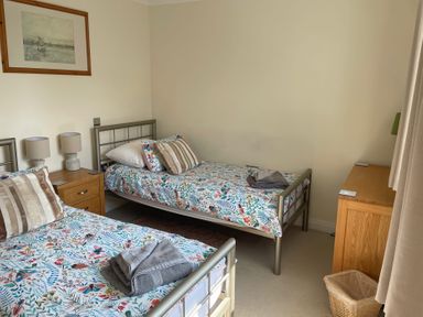 A bedroom with two single beds and bedside tables at 3 Strawberry Close Little Haven near Broad Haven
