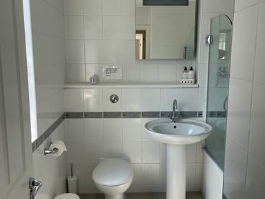 A bathroom with a sink, toilet, and shower at 3 Strawberry Close Little Haven near Broad Haven