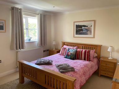 A bedroom with a bed and bedside tables at 3 Strawberry Close Little Haven near Broad Haven