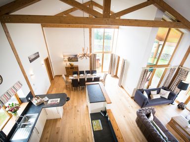 An open plan room with kitchen area dining table and living area at Aurae in Cawdor near Inverness