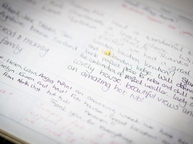 A close up of handwritten notes in a guestbook or journal