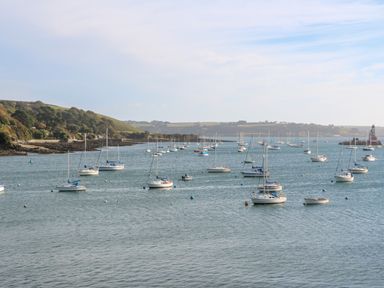 Many sailboats on a body of water with grassy hills in the background at 20 Bishops Way in Falmouth