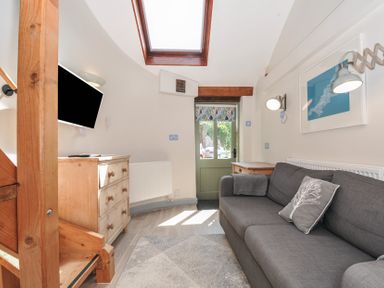 A living room with a sofa and television at Little Coombe Trehunist near Liskeard