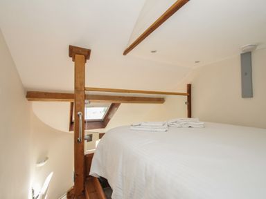 A bedroom with a bed and towels on top at Little Coombe Trehunist near Liskeard
