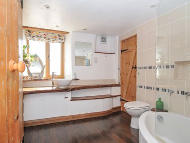 A bathroom with a sink, toilet and bath at Little Coombe Trehunist near Liskeard