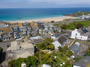 A coastal village with houses a beach and the ocean in the background at Ayr Farmhouse in St Ives