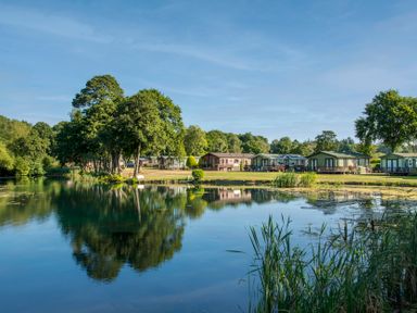 A view of caravans by a lake at Swan in Shobdon