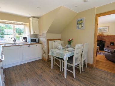 A kitchen with a dining area and appliances at Felin Gogoyan Tregaron