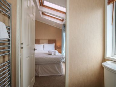 A bedroom with a bed and towels at Daisy in Eardisland