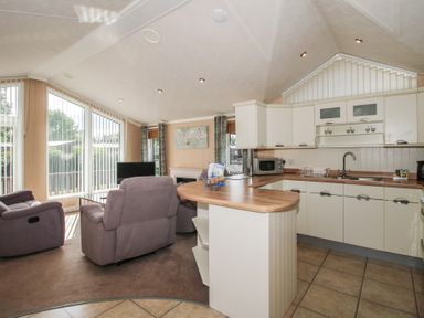 A living room with a kitchen area at Daisy in Eardisland