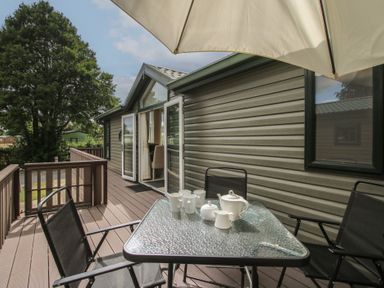 A patio with a table and chairs at Daisy in Eardisland