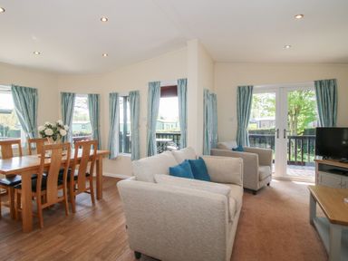 A living room with a dining area and sofa at Daffodil in Eardisland