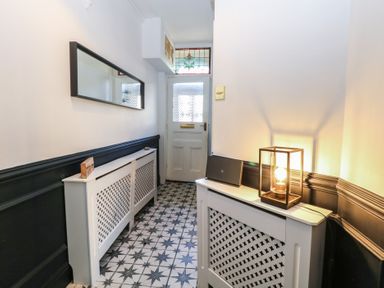 A hallway with a console table and mirror at Sunrise House in Pakefield near Lowestoft
