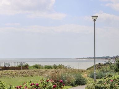 A view of the sea with a lamp post and flowers at Sunrise House in Pakefield near Lowestoft