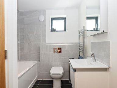 A bathroom with a bathtub toilet sink and mirror at Pebble Ridge View in Westward Ho