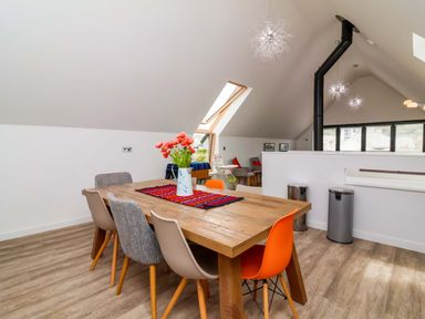 A dining room with a table and chairs at Pebble Ridge View in Westward Ho!