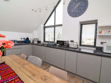 A kitchen with cabinets, sink and appliances at Pebble Ridge View in Westward Ho!