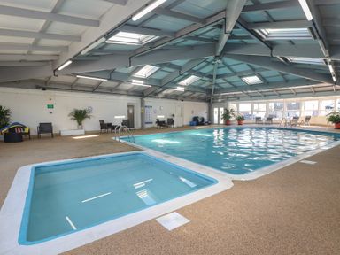 An indoor pool area at Three Views Lodge in Whitsand Bay Fort Holiday Village