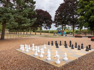 A chessboard with large chess pieces in a park at Dove in Shobdon